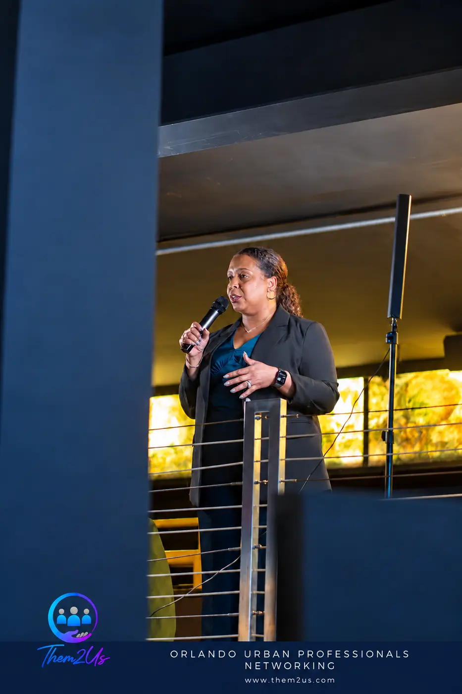 A speaker addressing the room at Them2Us Urban Professionals Networking in Orlando