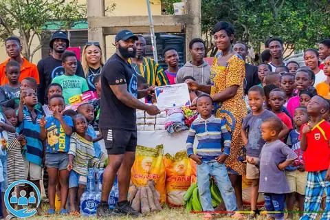 Them2Us donation ceremony with signed receipt