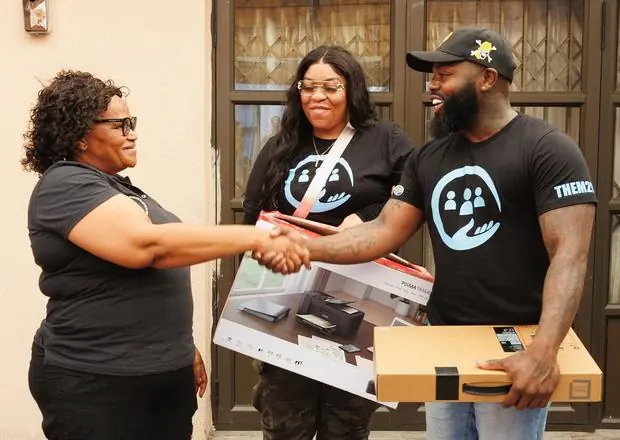 Them2Us delivering a laptop and printer on a mission